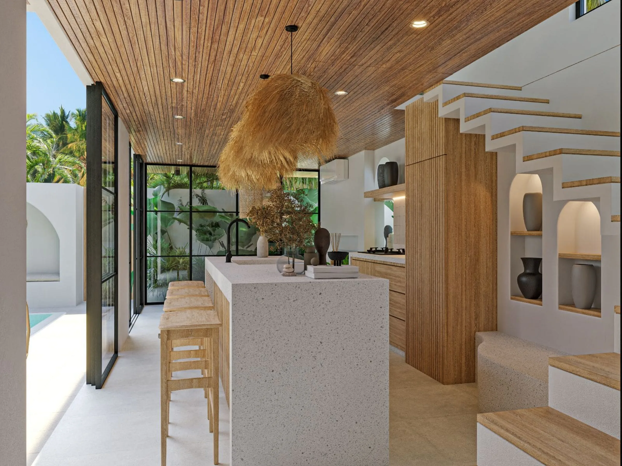 Kitchen with a terrazzo island, timber stair and arched display niches at Casa Cemagi