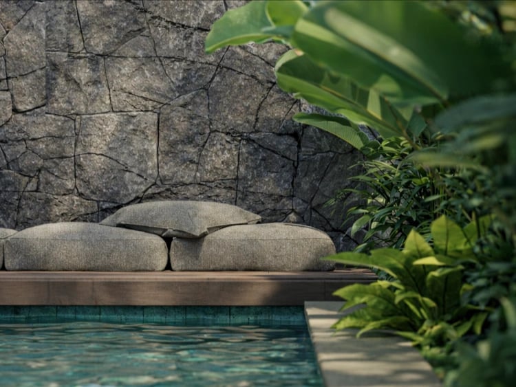 Nara Villas pool area with natural stone wall and timber deck