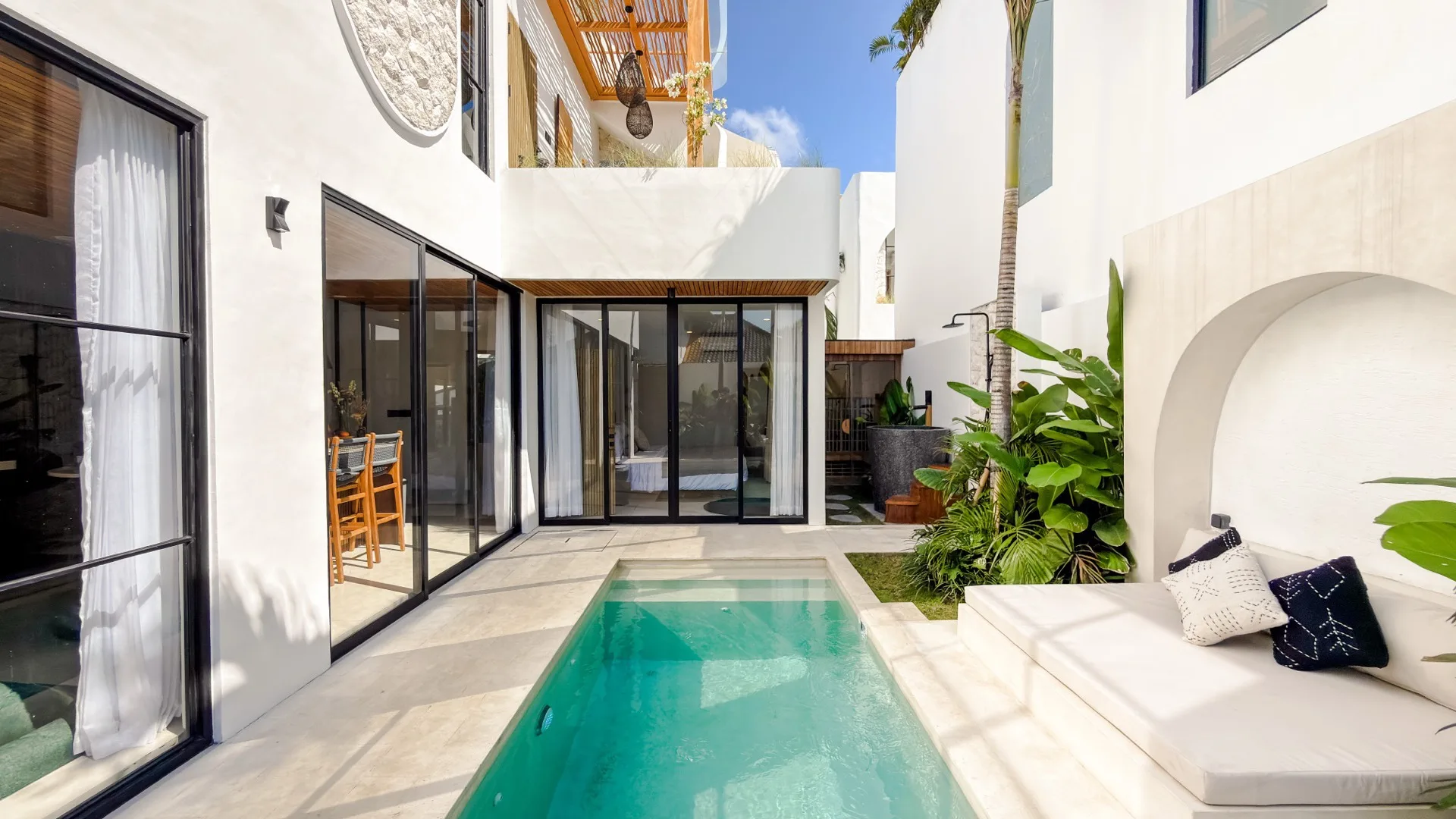 Solas Uluwatu terrazzo pool with an arched sunken daybed niche and tropical planting
