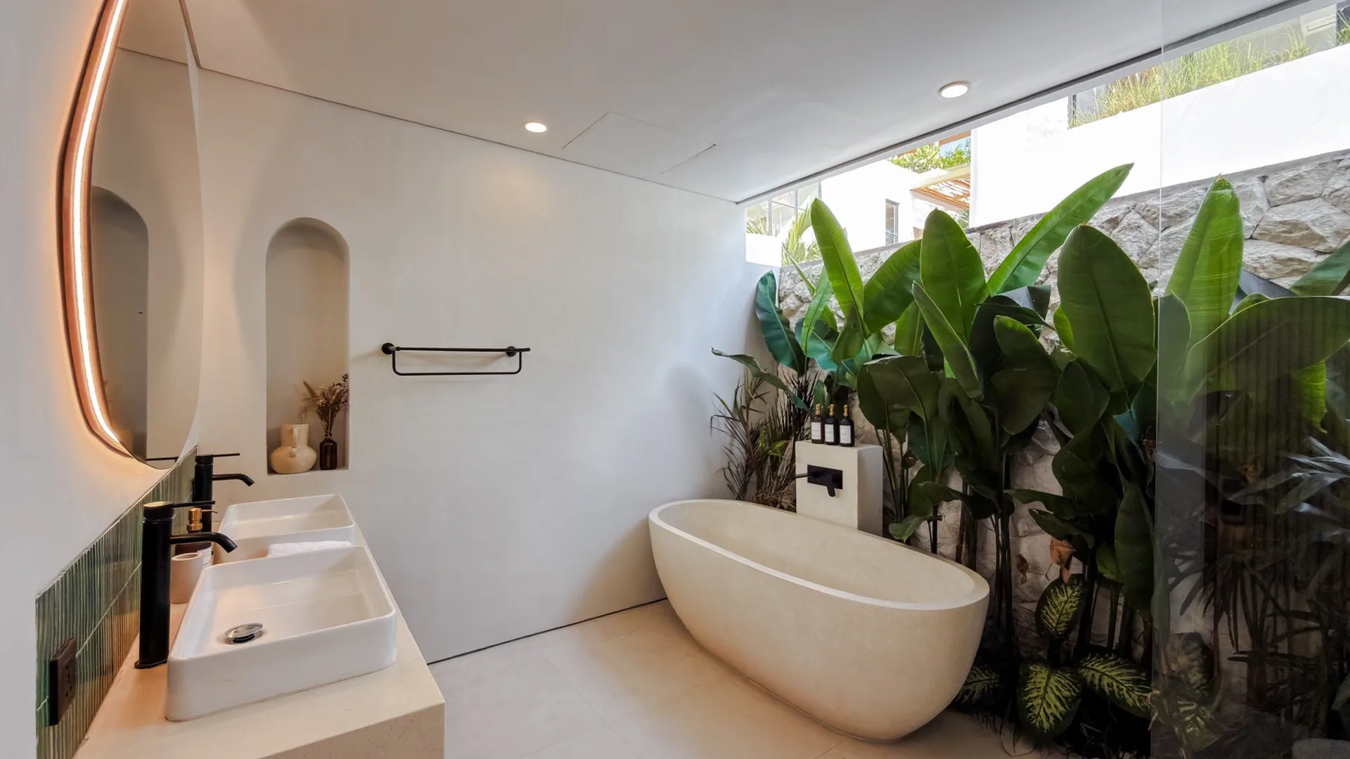 Solas Uluwatu spa bathroom with a freestanding stone tub and a double terrazzo vanity