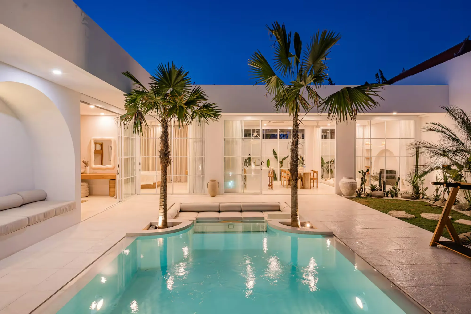 Pool courtyard of a completed Balitecture villa at dusk, Bali